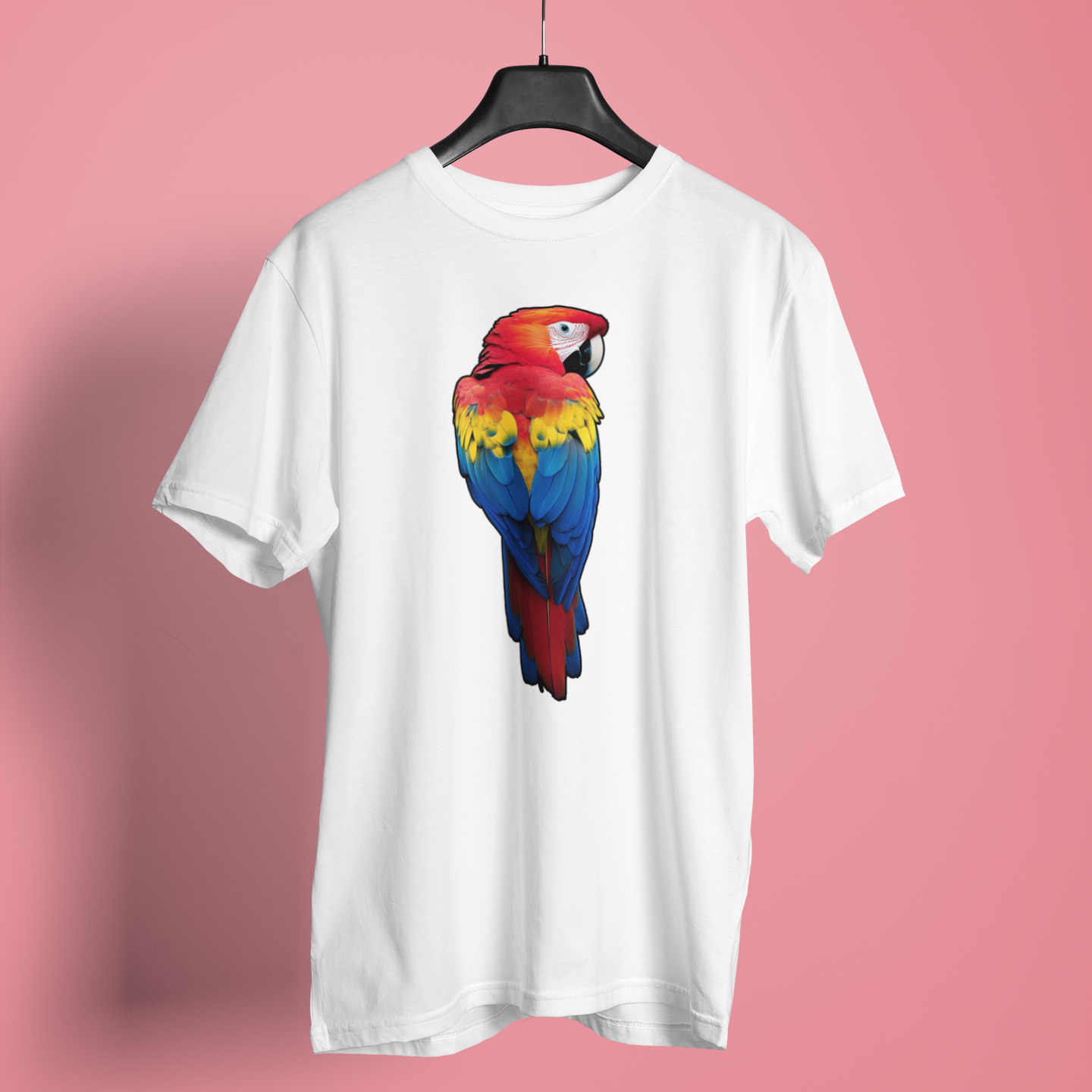 Bright scarlet macaw parrot with red, yellow and blue feathers on a white t-shirt