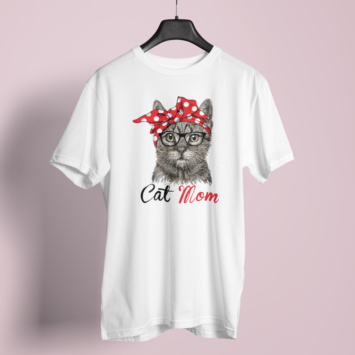 White t-shirt with a graphic of a cat wearing a red bandana and glasses, with 'Cat Mom' text, on a pink background.