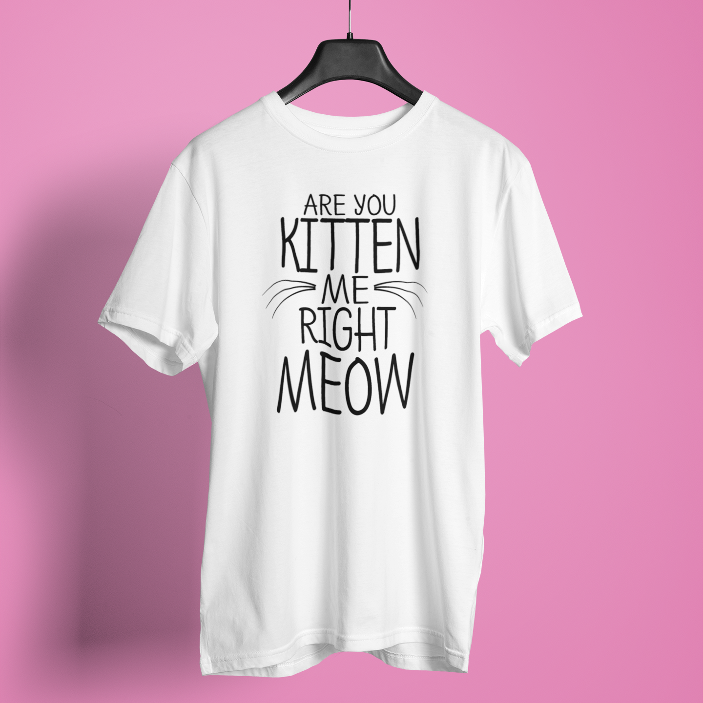 White t-shirt with humorous text design on a pink background