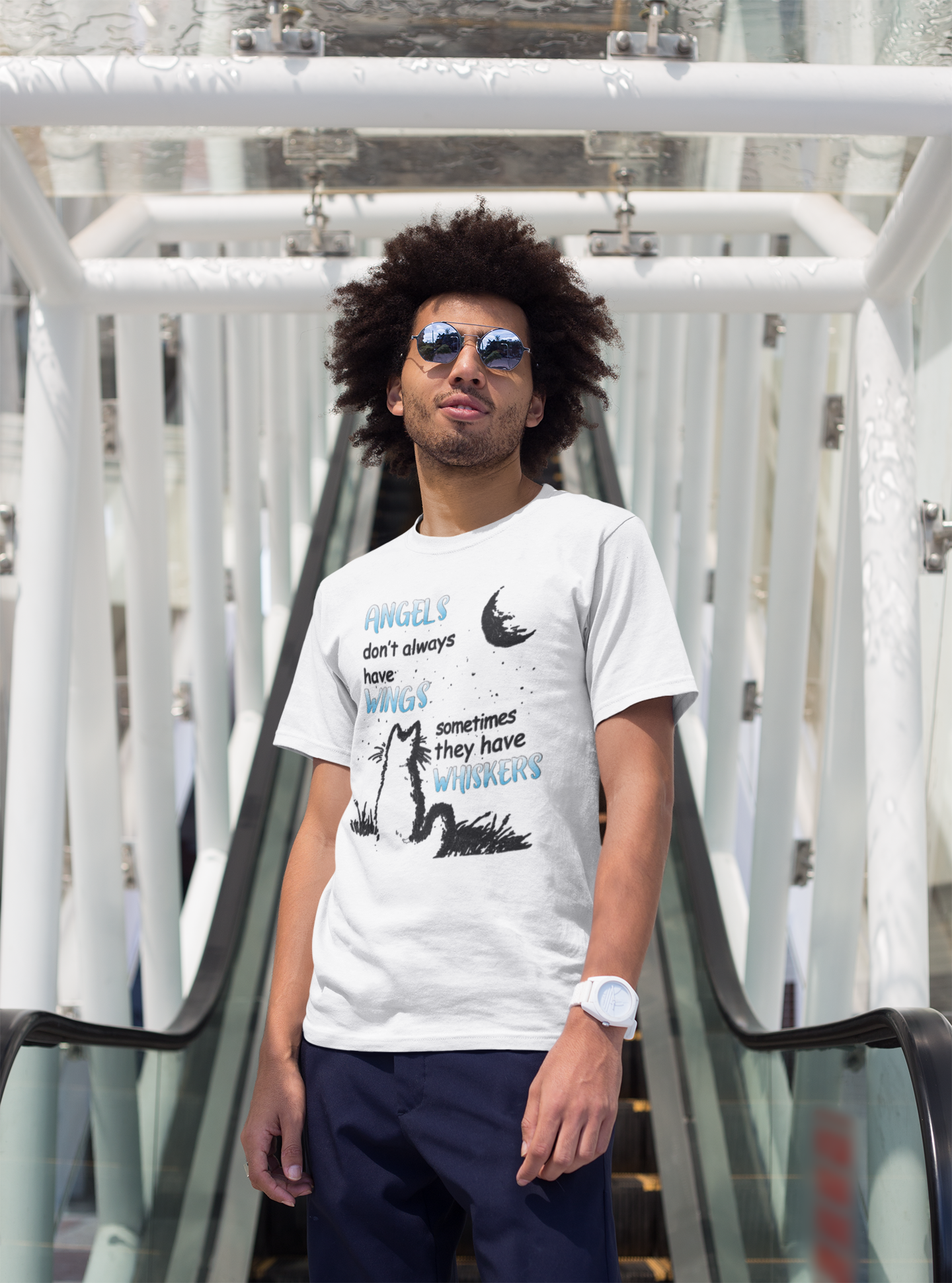 Man wearing a white t-shirt with graphic design and sunglasses, standing on a modern architectural background.