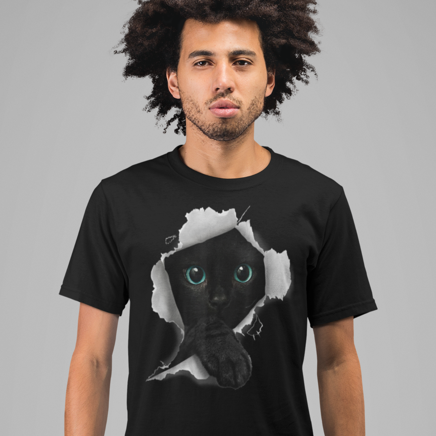 Man wearing a black t-shirt with a graphic of a cat's face.