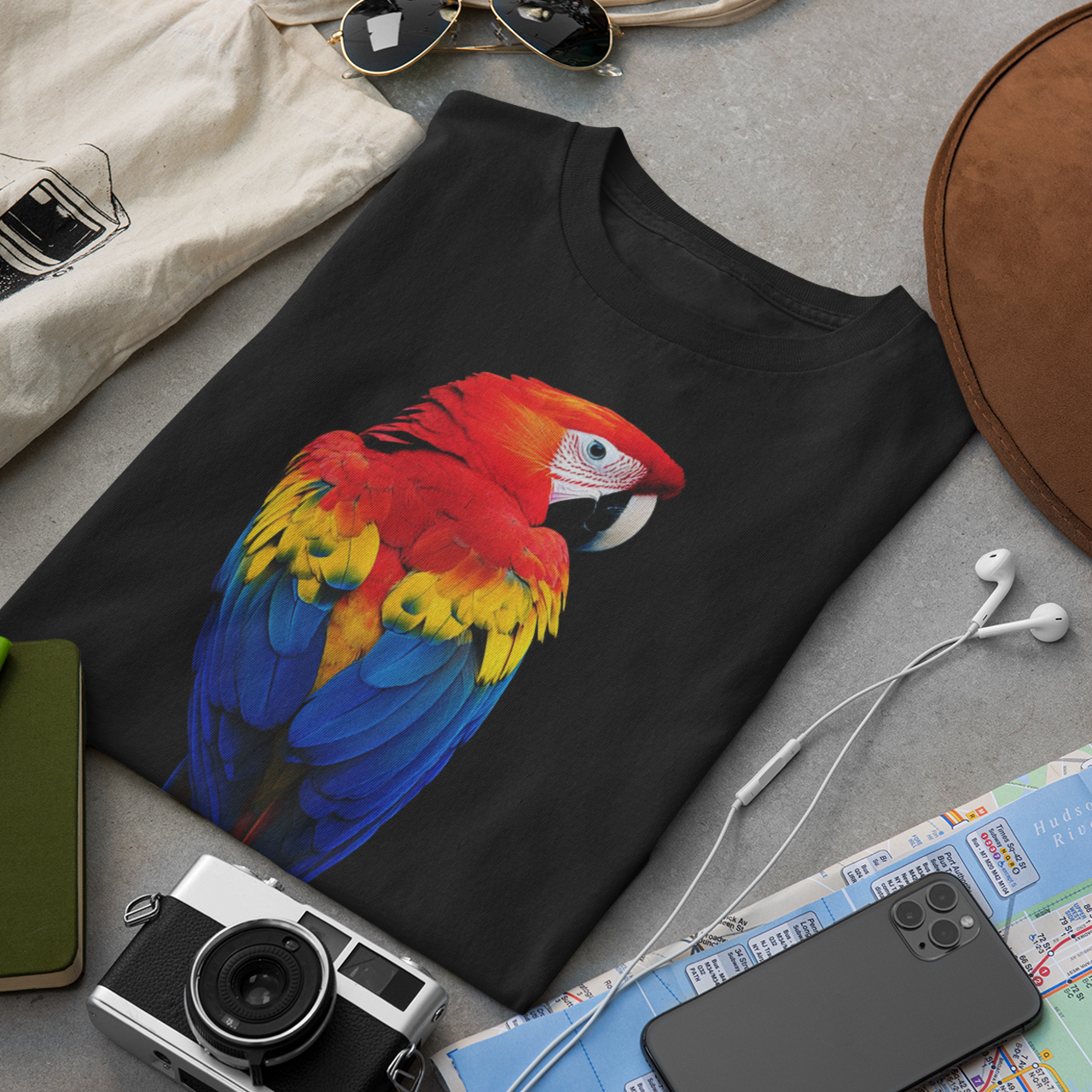 Bright scarlet macaw parrot with red, yellow and blue feathers on a black t-shirt