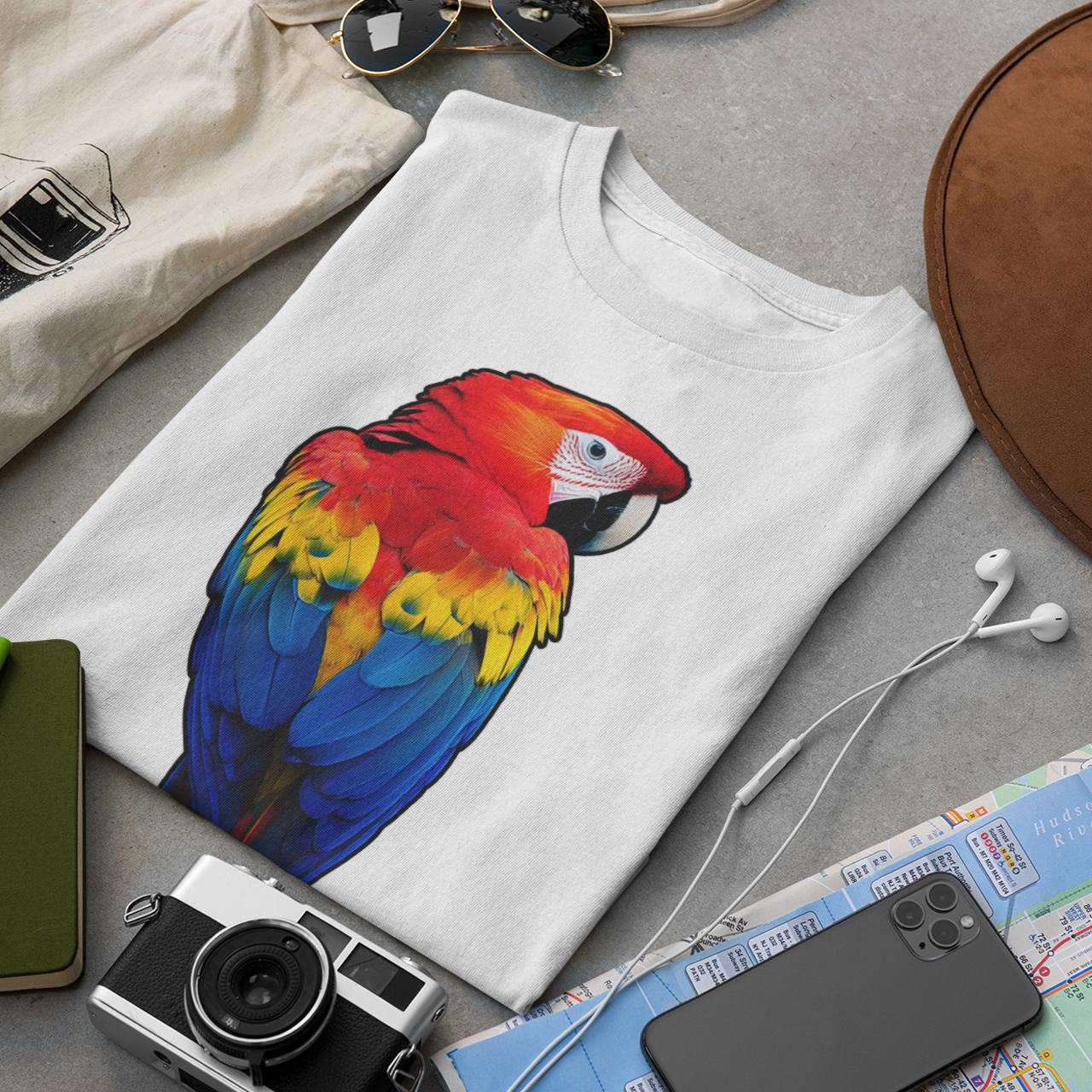 Bright scarlet macaw parrot with red, yellow and blue feathers on a white t-shirt
